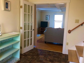 A hallway leading to a bedroom with a bed, a TV, and a staircase. - 3 Bedroom 2 1/2 Bath Apartment With Views of Rocklan (Rockland)