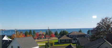 A residential area with houses, a clear sky, and a view of the water.