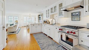 A kitchen with white cabinetry, a gas stove, and a built-in oven. - Oceanfront Home Incredible Ocean Views, Deck & Location (East Boothbay)