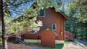 A log cabin with a wooden exterior, a front door, and a small porch. - Dog-friendly Lakefront Home With Deck, Grill, Wifi, Shared Dock & Water Access (Greenville)