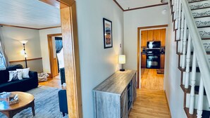 A modern interior with a living area, a kitchen, and a staircase. - Lake & Trail Landing- ATV & Snowmobile Access (Greenville)