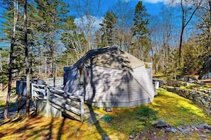 A cabin with a sloped roof, surrounded by trees and a wooden deck. - Geodesic Dome w/ Riverfront Deck, Lovely Views, & High-speed Wifi - Dogs Welcome (Boothbay)