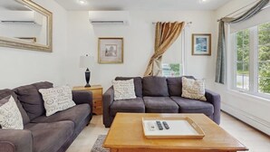 A living room with two sofas, a coffee table, a side table, and a large window with curtains. - Ideally Located Home w/ Deck, Wifi & Washer/dryer - Walk Into Town & Acadia (Bar Harbor)