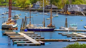 A marina with multiple boats docked, a pier, and houses in the background. - Waterfront Dog-friendly Cottage With Amazing Views, Deck, Grill, & Washer/dryer (Cushing)