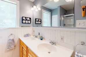 A bathroom with two sinks, a large mirror, and wall decorations. - Secluded Waterfront Home With Firepit, gas Grill, Kayaks, Dock, Balcony, & Patio (Phippsburg)
