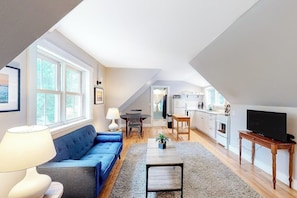 A modern loft apartment with a living room, kitchen, and dining area. - Friendly Home With our Separate Condos & Free Wifi in the Heart of Downtown (Castine)