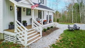 A house with a porch, steps, and a flag. - Birch Tree Retreat, 6-bedroom Family Getaway Spot (South Thomaston)
