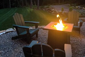 A fire pit with chairs around it, set on gravel. - Amazing All-season Sprucewold Cabin w/ Private Beach Club Access Dog-friendly (Boothbay Harbor)