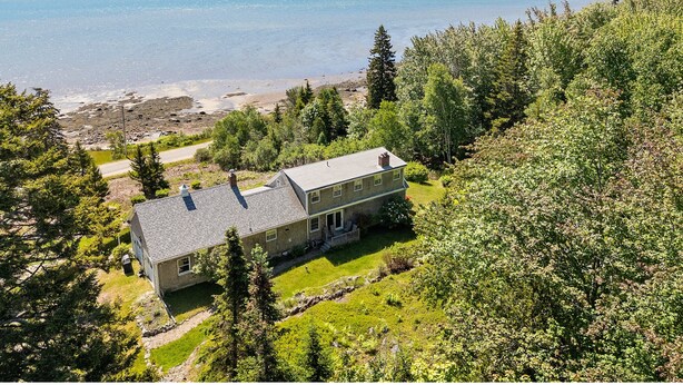 A house with a large lawn, a view of the sea, and a forested area. - Dog-friendly Oceanfront Home With Private Shorefront, two Fireplaces, & Firepit (Steuben)