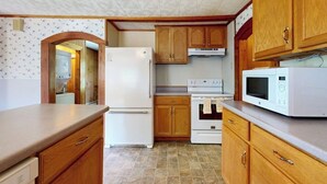 A kitchen with wooden cabinets, a refrigerator, an oven, and a microwave. - Dog-friendly, Bay View Home With Wifi & Laundry - Close to Baxter State Forest (Bowdoinham)
