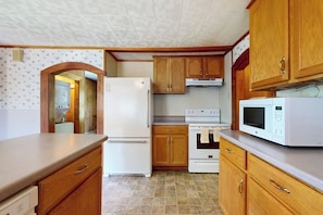 A kitchen with wooden cabinets, a refrigerator, an oven, and a microwave. - Dog-friendly, Bay View Home With Wifi & Laundry - Close to Baxter State Forest (Bowdoinham)