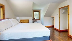 A bedroom with a bed, a window, a chair, and a wooden floor. - Dog-friendly, Bay View Home With Wifi & Laundry - Close to Baxter State Forest (Bowdoinham)