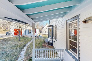 A house with a porch, a window, and a door.