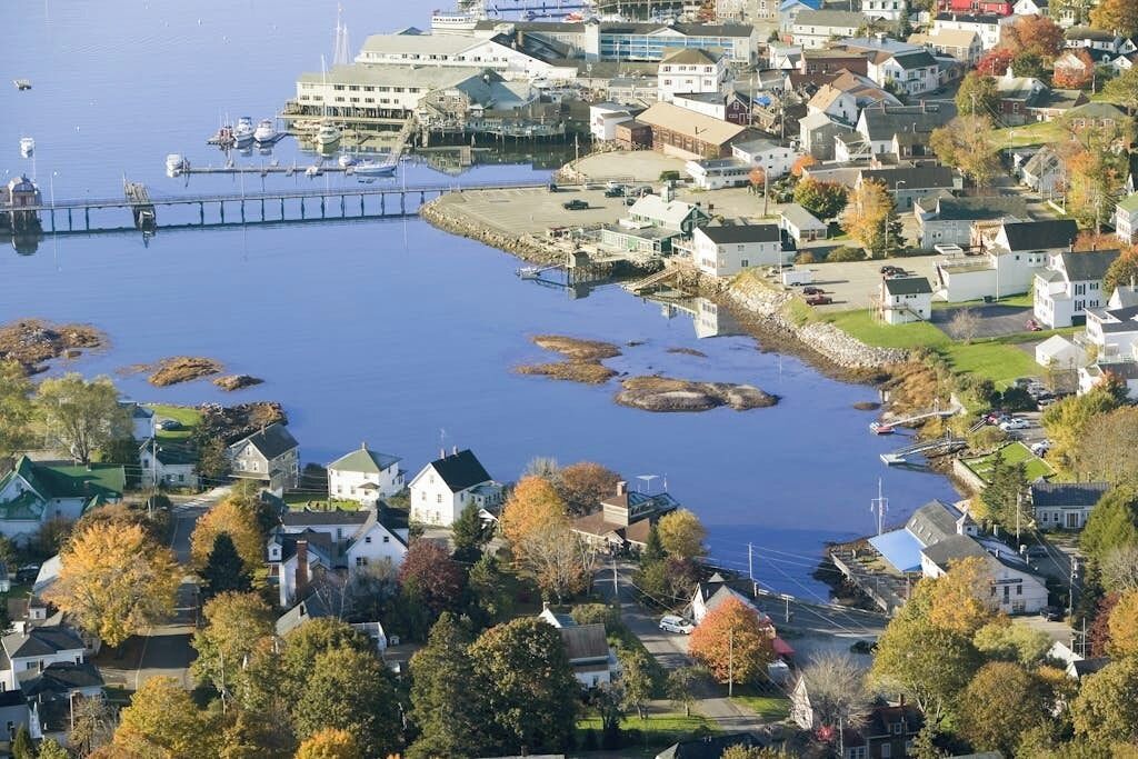 A coastal town with houses, a pier, and boats.