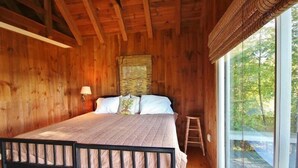 A wooden room with a bed, a window, and a ladder. - Tideriver, Waterfront Cottage in Maine (Port Clyde)