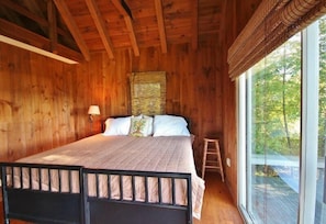 A wooden room with a bed, a window, and a ladder. - Tideriver, Waterfront Cottage in Maine (Port Clyde)