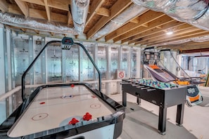 An indoor recreational area with a foosball table, a shuffleboard table, and insulated walls. - Salt & Cedar House -large gathering spaces, 5 min to stone harbor, Bar&Game Room (Middle Township)