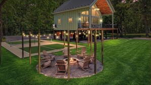 A house with a deck, outdoor seating, and a fire pit. - River Run - Riverfront+Pickleball+Hot Tub+Sauna (Shenandoah)