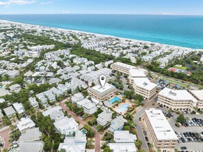 An aerial view of a coastal residential area with a large hotel featuring a swimming pool and a parking lot. - The Current 331 - Just Redecorated Spacious Condo - Sleeps 8 (Inlet Beach)