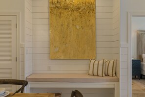 A room with a bench, a wall-mounted artwork, and a door. - The Current 331 - Just Redecorated Spacious Condo - Sleeps 8 (Inlet Beach)