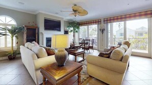 Ein Wohnzimmer mit Kamin, zwei Sofas, einem Couchtisch und einem Deckenventilator.