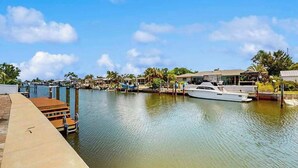 A marina with boats docked, a wooden dock, and a clear sky. - Waterfront home with private, heating optional pool, lanai, and internet (Bradenton)