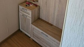 A room with a wardrobe, a small table, and a mirror. - Serene 1-bedroom apartment in charming Liepāja perfect for relaxing (Liepāja)