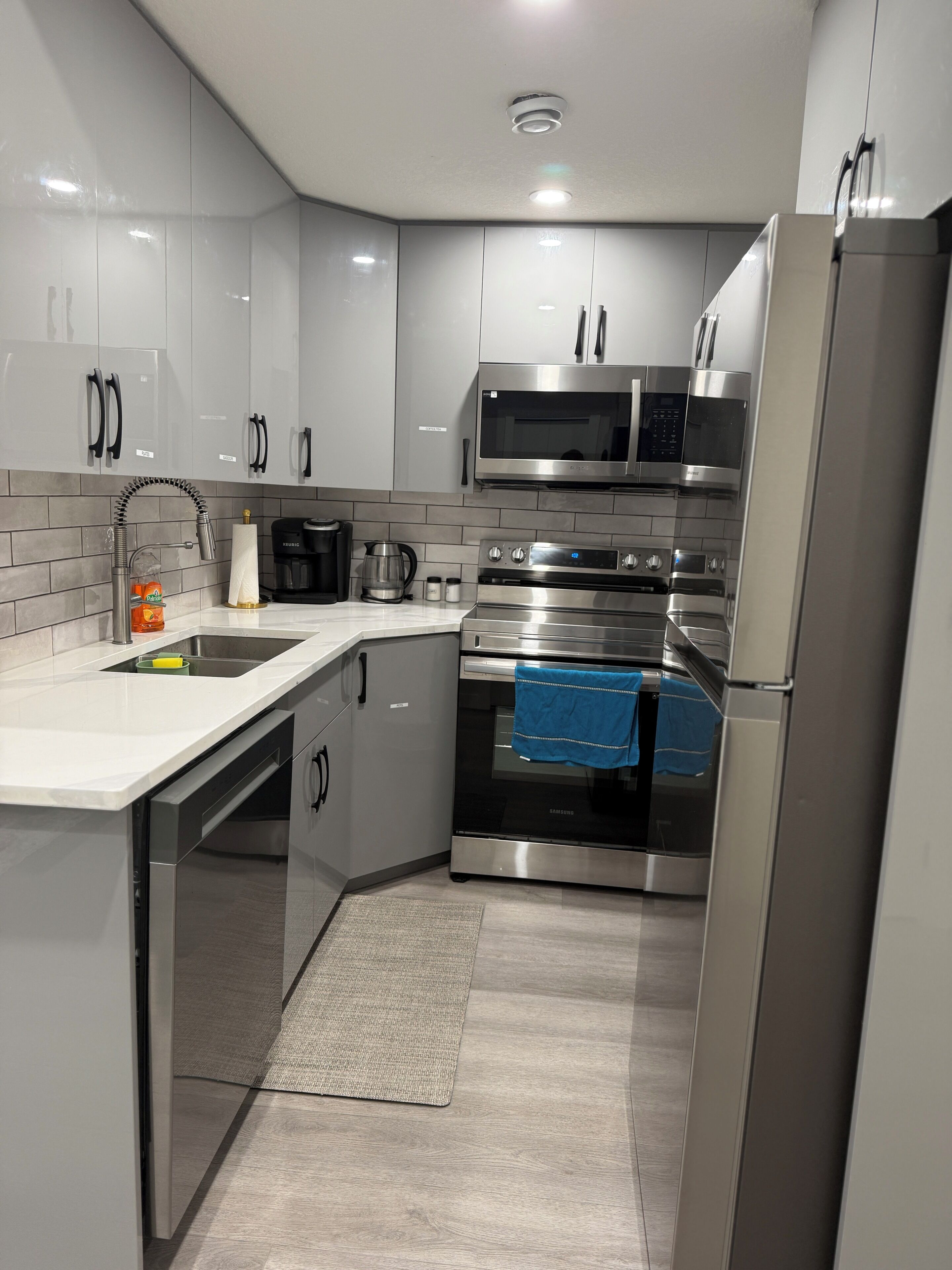 A modern kitchen with stainless steel appliances, a built-in oven, and a microwave.