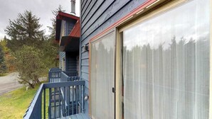 A house with a covered porch, a garage door, and a chimney.