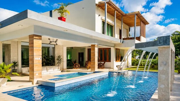 A modern house with a swimming pool, a covered patio, and a two-story structure. - Luxury 7BR Estate w/Private Pool in Puerto Plata (Star Hill)