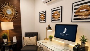 A modern office space with a desk, chair, computer, and decorative items. - Cozy 1-bedroom studio in welcoming North Miami Beach with AC (North Miami Beach)