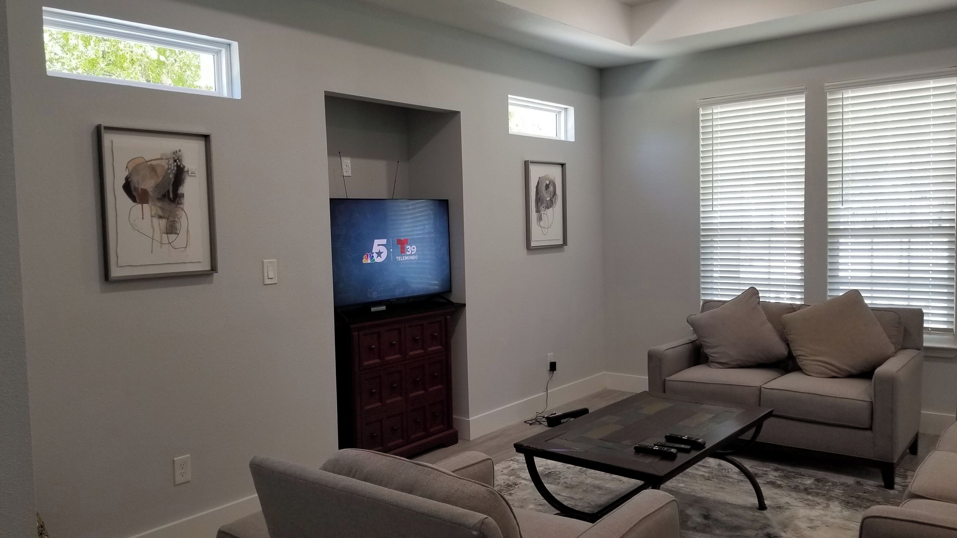 A living room with a television, sofa, and coffee table.