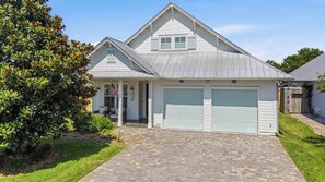 A single-story house with a garage, a covered porch, and a well-maintained lawn. - Coastal Retreat with Private Pool - Minutes from 30A Beaches (Santa Rosa Beach)