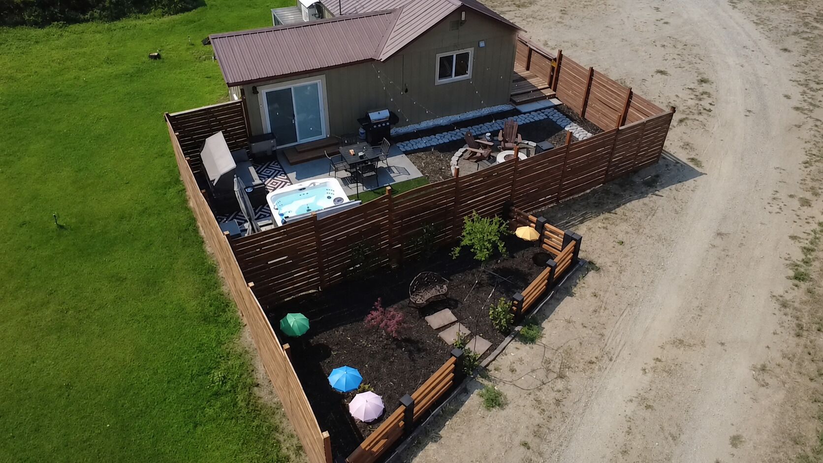 A house with a patio, outdoor seating, and a hot tub.