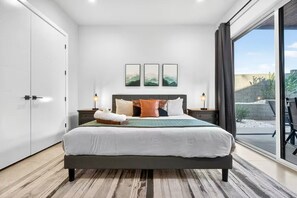 A modern bedroom with a large bed, a wardrobe, and a view of the outdoors. - 24 Guests l Private Pool/Spa l Mansion (Hurricane)
