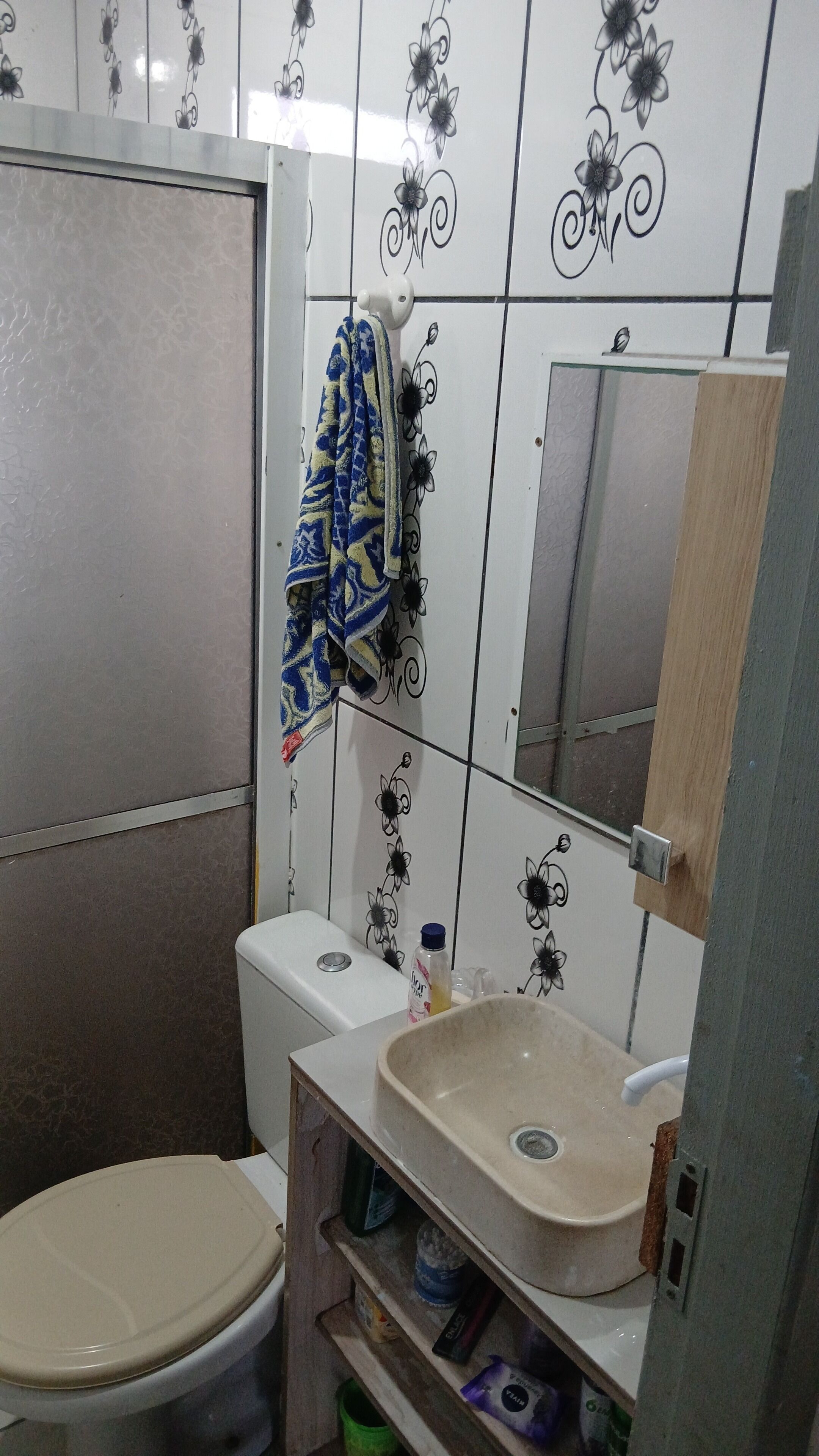 Une salle de bain avec des toilettes, un lavabo et un miroir.