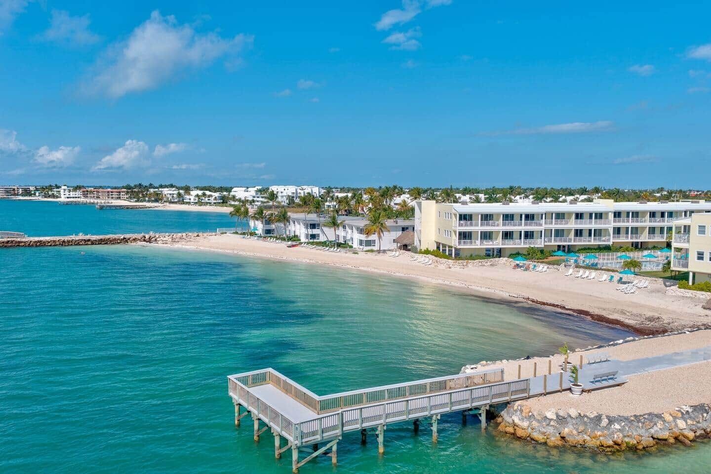 A coastal hotel with a pier, beachfront, and ocean views.
