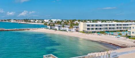 A coastal hotel with a pier, beachfront, and ocean views.