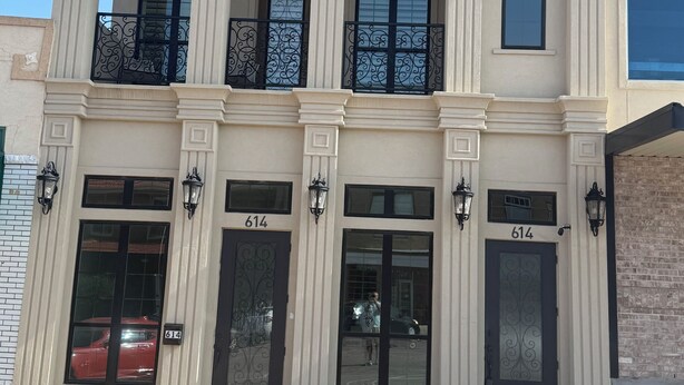 A building with a sign reading 'MARR 2019' above the entrance, featuring a classical architectural style with columns and decorative railings. - Marr Building North Condo, Downtown Denison, Denison, Texas, Lake Texoma (Denison)