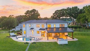 A two-story house with a swimming pool, outdoor seating, and a covered patio. - Waterview Oasis | Pool & hot tub| Game Room | Outdoor Kitchen (Terrell)
