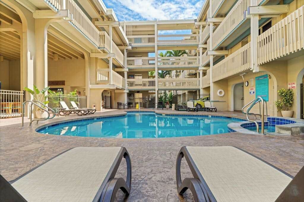 A multi-level pool area with lounge chairs and a central swimming pool.
