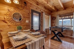 Ein Holzinterieur mit Essplatz, einem Spiegel und einem Kicker.