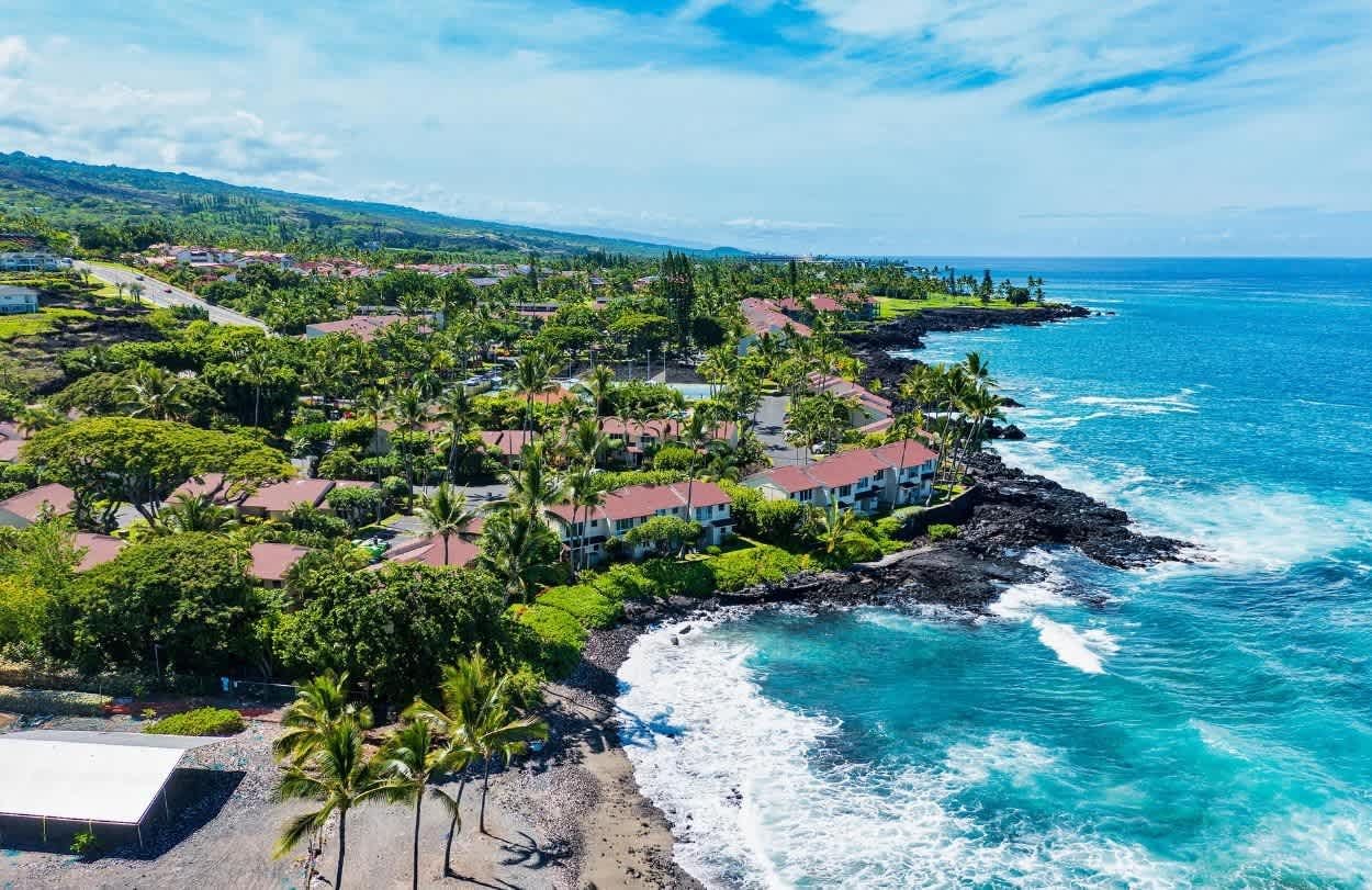 A coastal resort with multiple buildings, a beach, and ocean views.