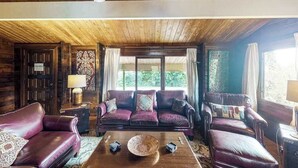 A wooden ceiling, a sofa set, a coffee table, and a window with curtains. - New Fall $pecial Nearly Two Rainforest Acres by Volcanoes National Park (Volcano)