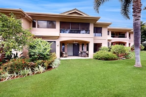 A two-story house with a front porch, a covered patio, and a well-maintained lawn. - *NEW* Fall Special Renovated Waikoloa Village Retreat Near Dining (Waikoloa)