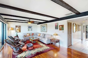 A living room with a sofa, chairs, a coffee table, and a rug. - *NEW* Top Floor Kona Coast Views for a Family of Four (Kailua-Kona)