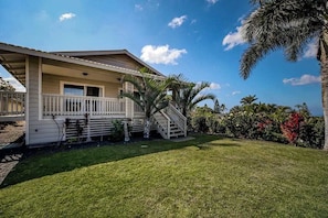 A single-story house with a front porch, a staircase leading to the entrance, and a well-maintained lawn. - *NEW* Pacific-View Waikoloa Home Near Golf and Beach Days (Waikoloa Village)