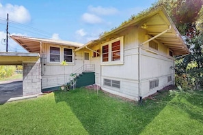 A single-story house with a front porch, a small staircase, and a green front yard. - *NEW* Hamakua Coast Country Home Near Hilo (Papaikou)