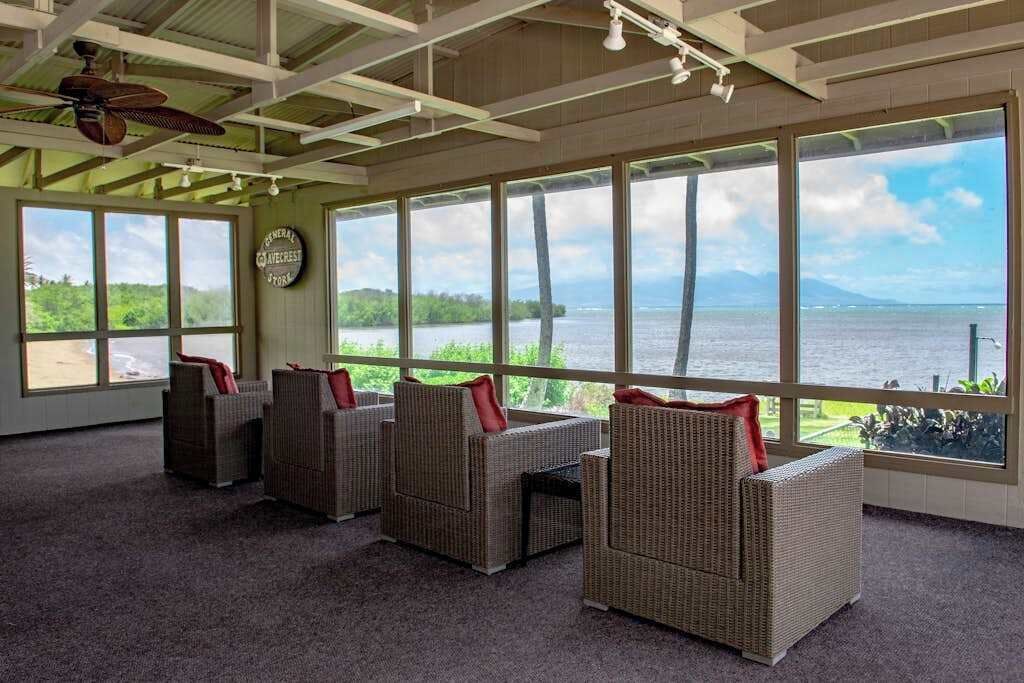 Covered lanai offers chairs, tables, ceiling fans, and ocean views
