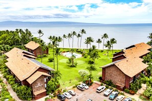 Ein Resort mit mehreren Gebäuden, einem Pool und Meerblick.